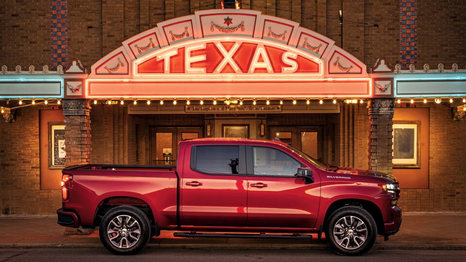 A red Silverado RST Diesel truck sits in front of the lighted marquee of the Texas Theatre in Seguin.