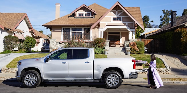 The 2020 Silverado LTZ sits at the curb in front of a house.