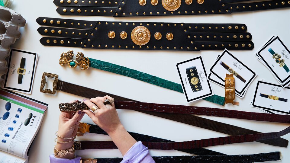A table full of vintage-style belts, seen from above.