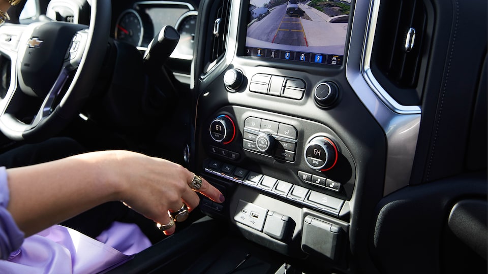 Beth Morgan pushes a button on the console of the 2020 Silverado LTZ.