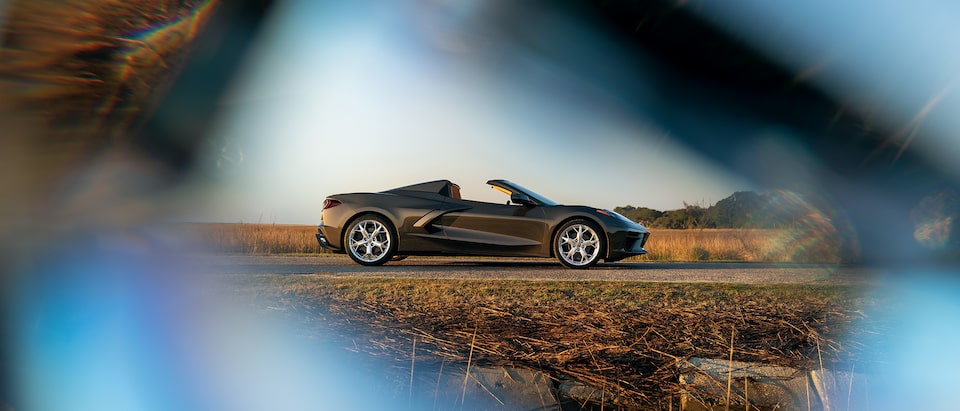 Un Corvette Convertible 2020 en Bronce Zeus Metálico por una carretera de Carolina del Sur con un filtro difuminado en los bordes de la foto.