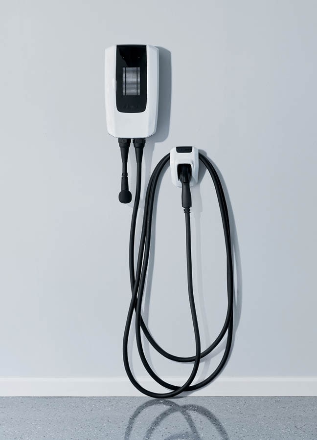 An Ultium Power-Up home charger mounted on a garage wall.