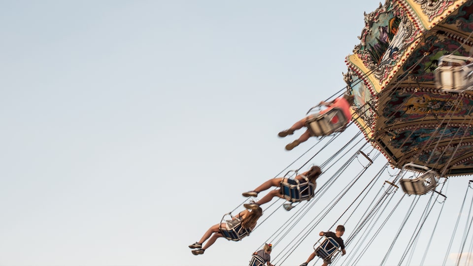 State fair attendees enjoy swinging through the summer sky.