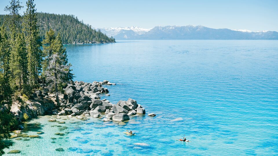 Kayakers paddle across Lake Tahoe in California.
