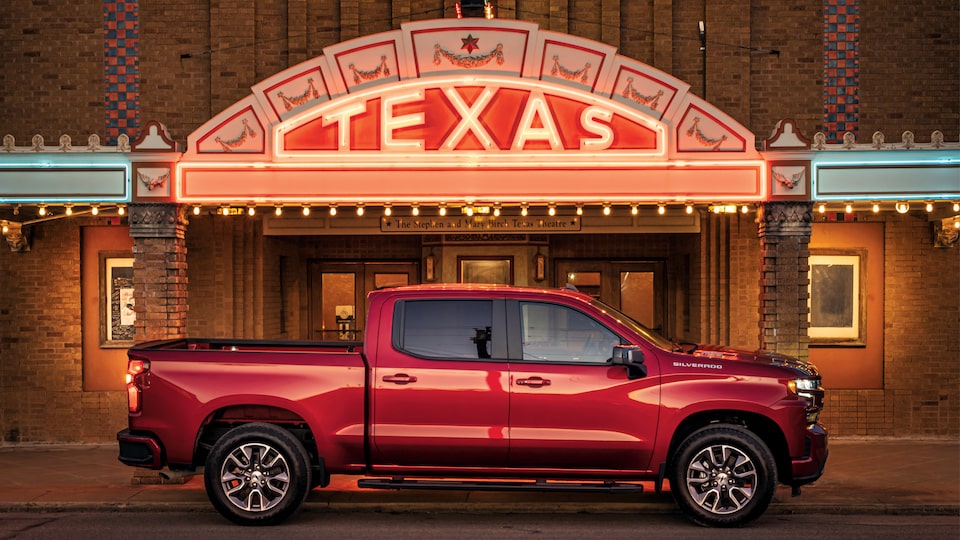 A red Silverado RST Diesel truck sits in front of the lighted marquee of the Texas Theatre in Seguin.
