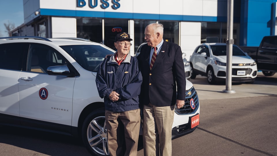 Reuben Schaetzel with George Patton Waters in front of the 2018 Chevy Equinox Waters bought from Schaetzel. The Equinox has a four-star license plate and Gen. George Patton's division medallion.