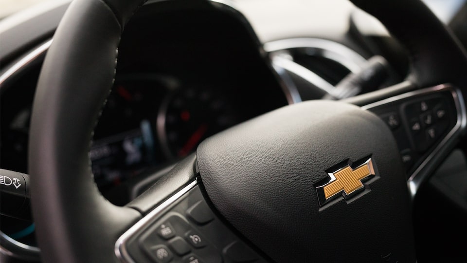 Close-up shot of the Chevrolet bow tie on the Malibu's steering wheel.