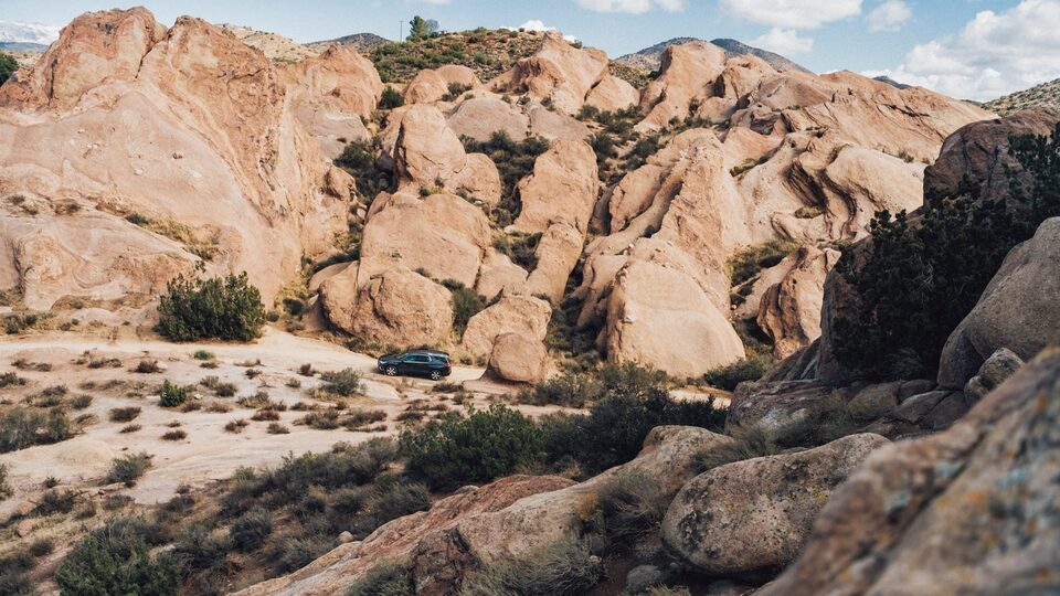 Chevrolet Traverse seen in a remote area between rock formations.