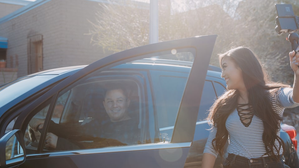 Vlogger Mo Calderon takes a self portrait in front of a Chevrolet Trax.