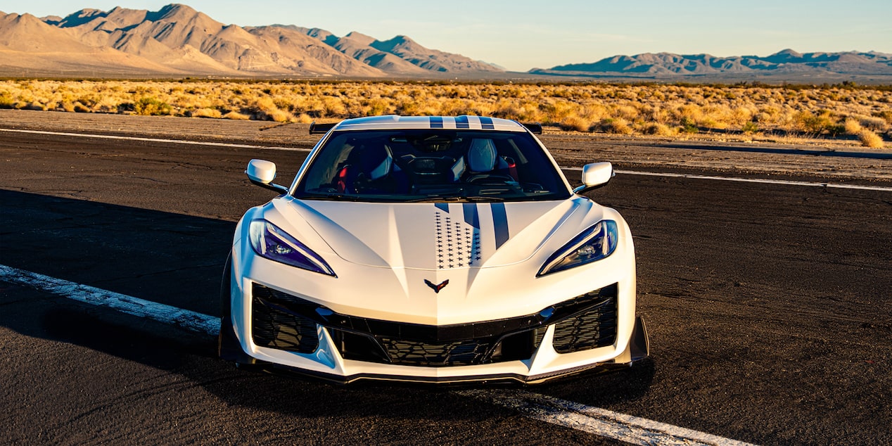 Front View of a White Chevy Corvette Parked on a Road.