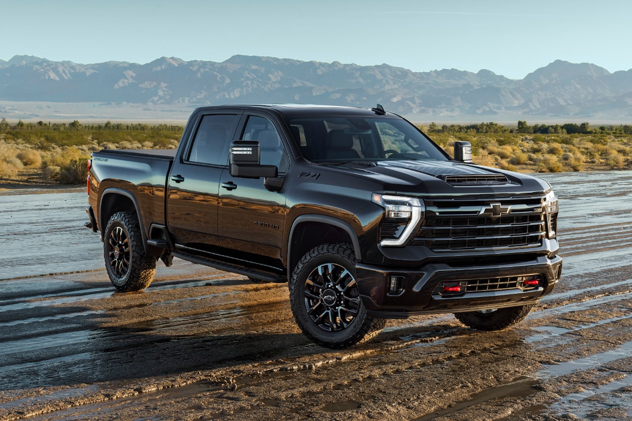 Front Three-quarter View of a Black 4-door Chevy Truck Parked on a Muddy Path.