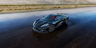 A Dark Blue Chevrolet Corvette Stingray from the Stars and Steel Collection on a Wet Runway.