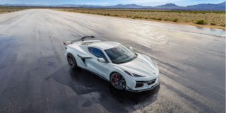A White Chevrolet Corvette Z06 from the Stars and Steel Collection on a Wet Runway.