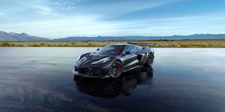 A Dark Blue Chevrolet Corvette Stingray from the Stars and Steel Collection on a Wet Runway.