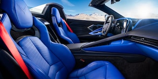 A Wide Interior Shot Of A Chevrolet Cabin Featuring Blue And Red Two-Tone Leather Sport Seats Against A Mountain Backdrop.
