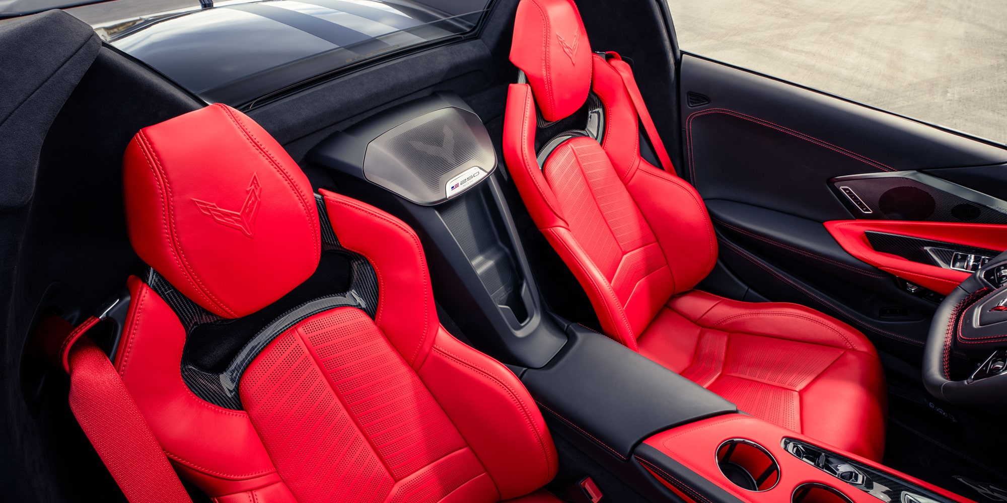 A Top-Down View Of A Chevrolet Interior Showcasing Bold Red Leather Sport Seats With Black Accents And A Center Console Divider.