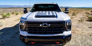 A Frontal View of the Chevrolet Silverado HD Truck, Displaying a Bold Grille and American Flag Hood Decal.