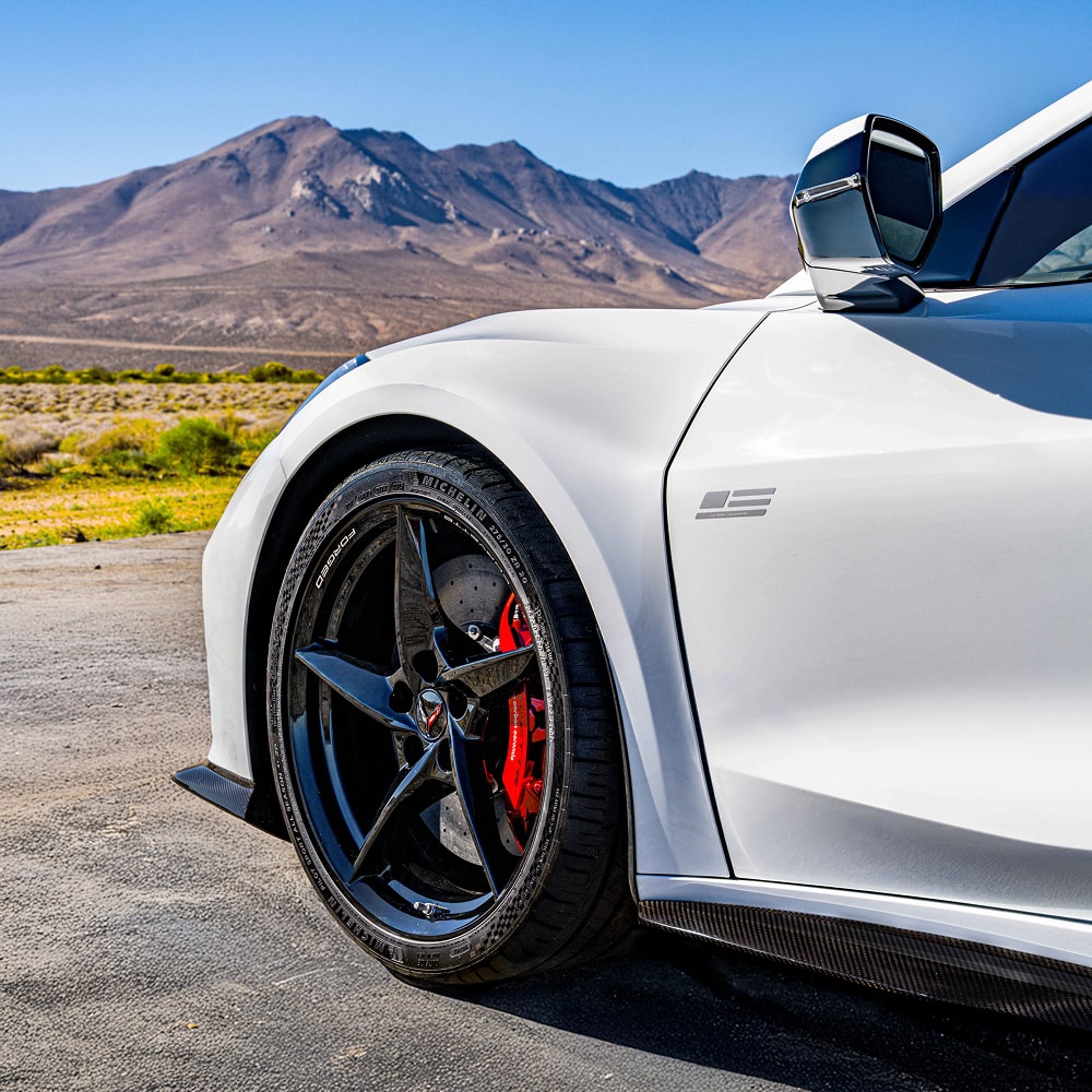 A Close-up View of the Driver Side Tire on a White Corvette.