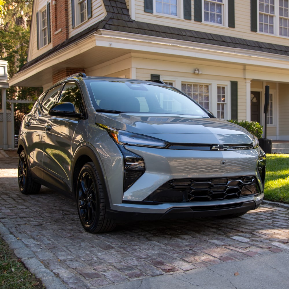 A 2027 Chevrolet Bolt in Sterling Gray Metallic Parked in a Driveway