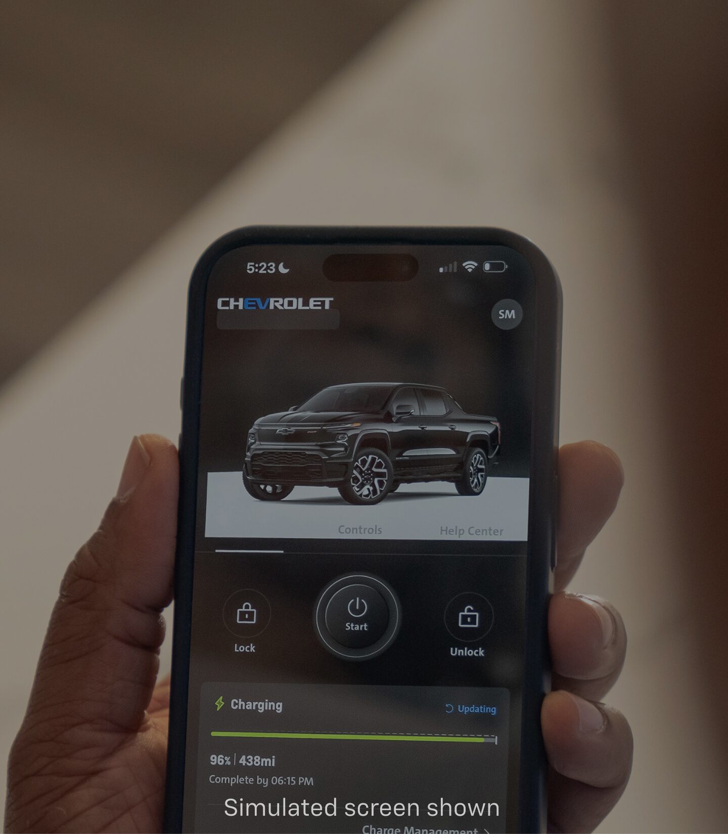 Hand Holding a Smartphone Displaying Chevrolet Vehicle Information in the myChevrolet App.