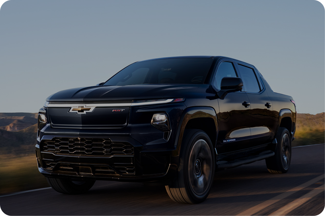 A Black Chevy Silverado Driving Down a Two Lane Road