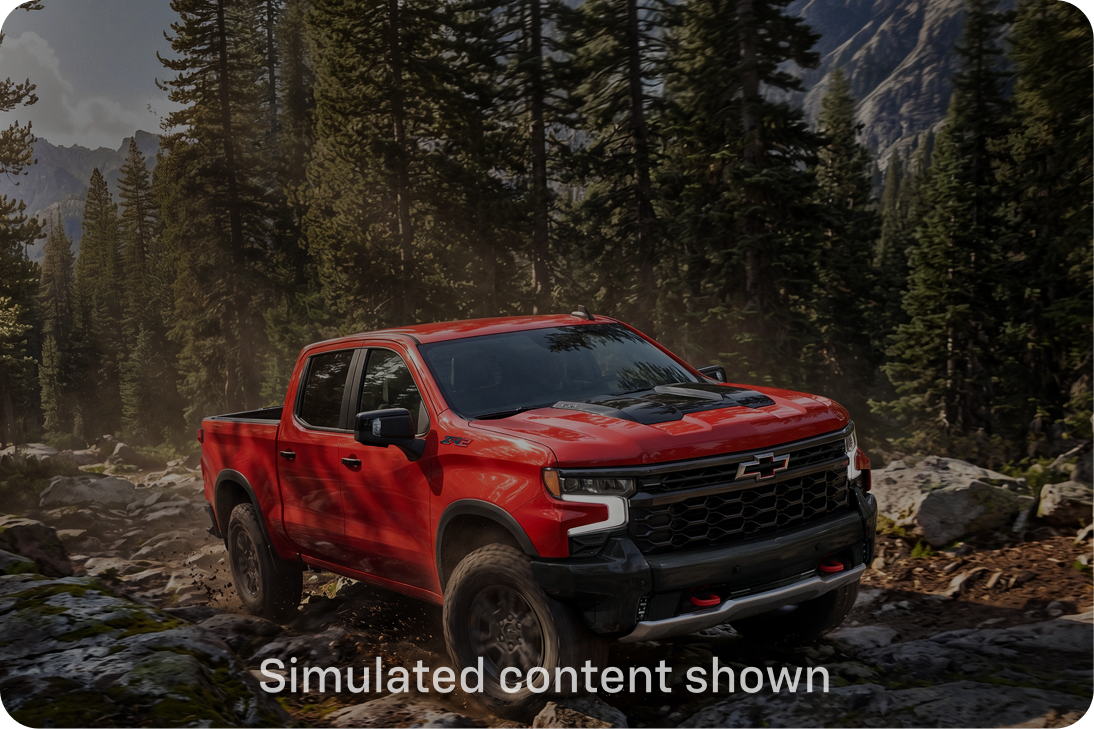 An Orange Chevy Silverado Off Roading in the Woods