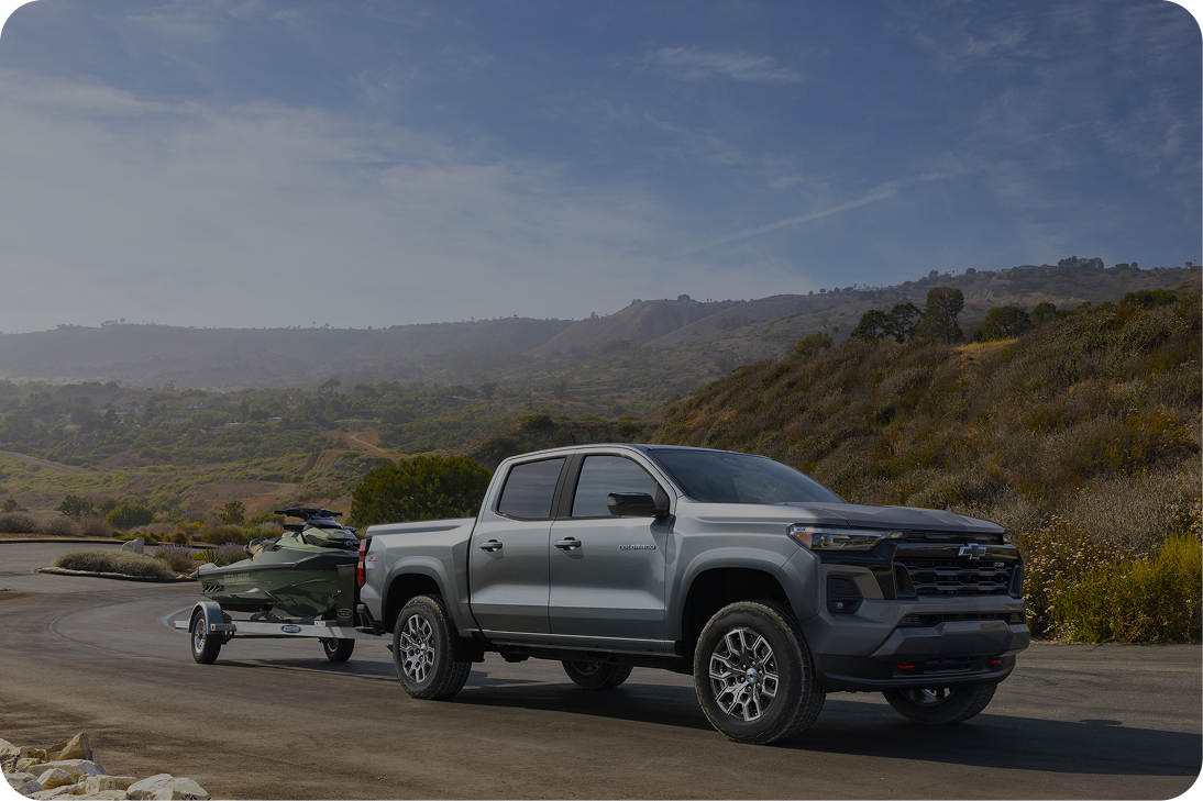 Grey Chevy Silverado Hauling a Jet Ski on a Road