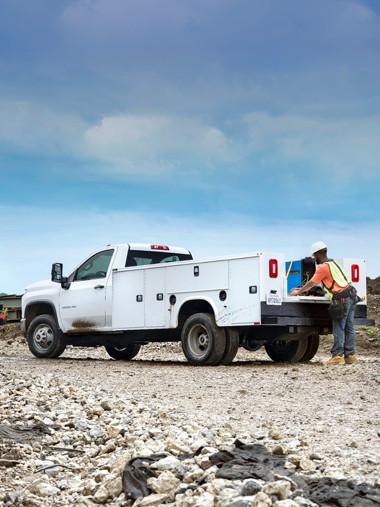A White Chevrolet Silverado 3500 HD Chassis Cab Truck on a Construction Site With the Text '2026 Silverado 3500 HD Chassis Cab'.