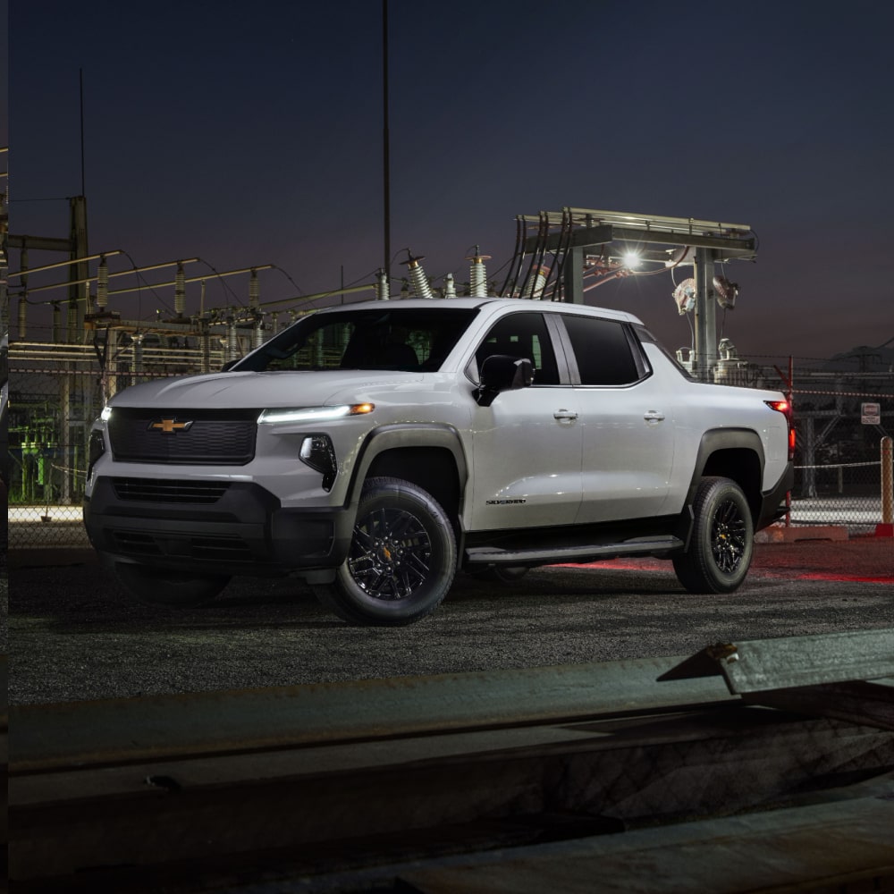 2027 Chevy Commercial Silverado EV Parked at a Construction Site at Night