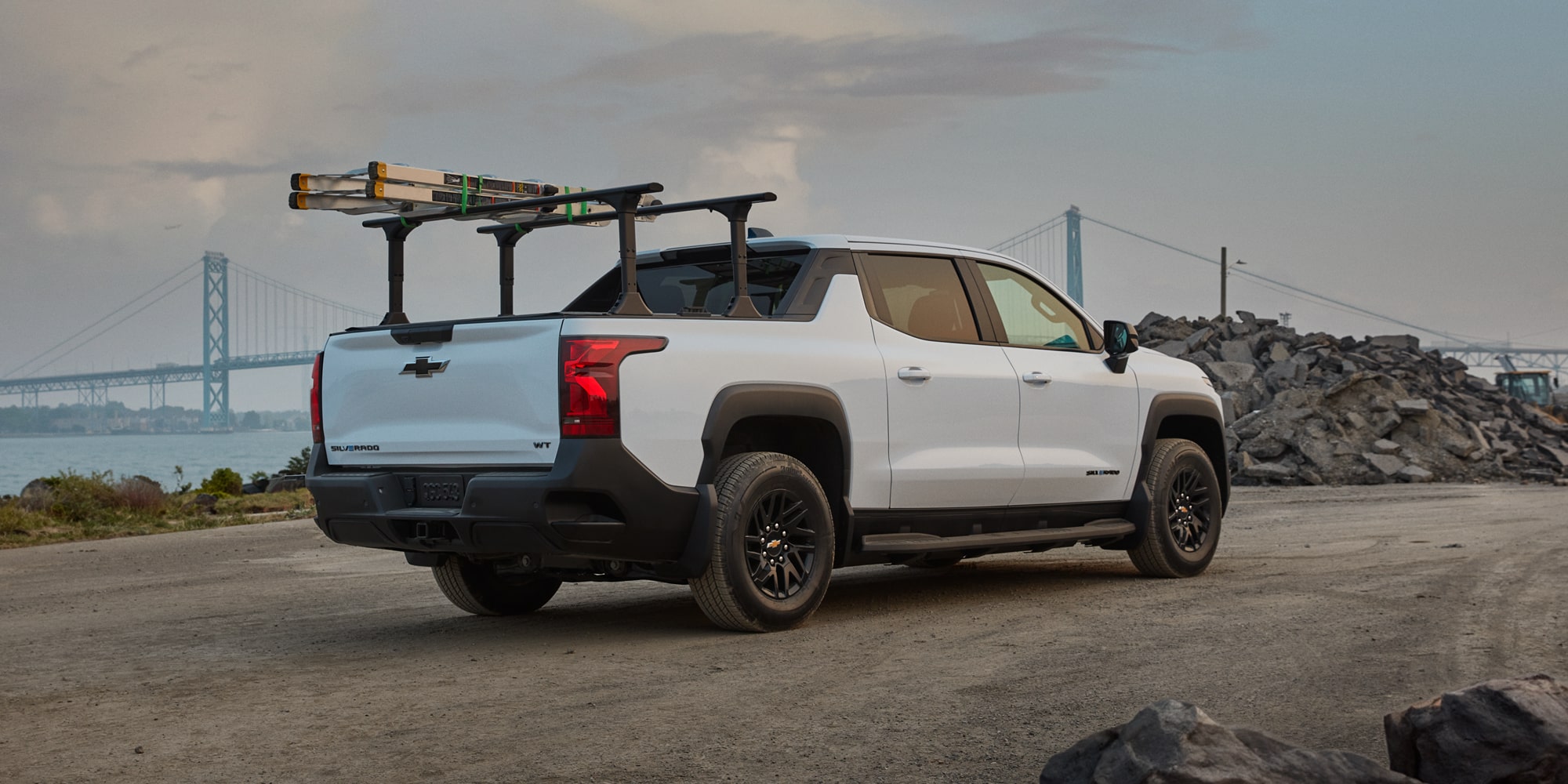 A Construction Worker Loading Equipment into the 2027 Chevy Commercial Silverado EV
