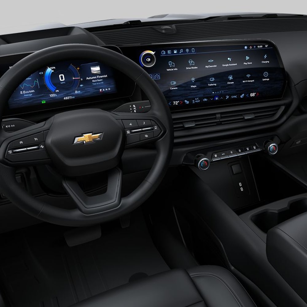 View of the Commercial Chevy Silverado EV Interior Featuring the Steering Wheel, Digital Driver Display, Expansive Infotainment Touchscreen, Center Console, and Dashboard Controls.