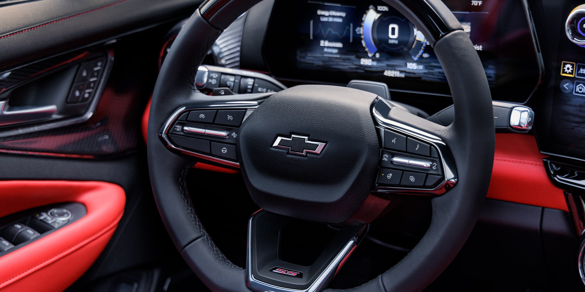The Interior View of a Chevrolet Blazer EV Showing the Steering Wheel With the Chevrolet Logo and a Digital Dashboard Displaying Speed and Vehicle Information.