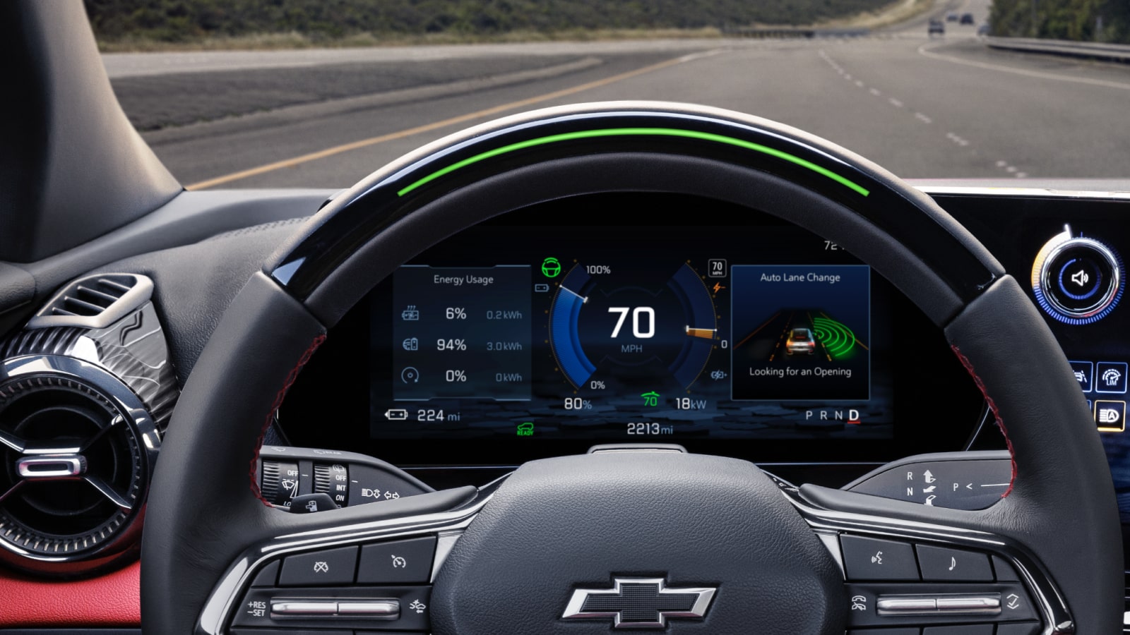 The Interior View of a Chevrolet Blazer EV Showing a Steering Wheel With the Chevrolet Logo and a Digital Dashboard Displaying Speed and Driving Information.