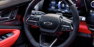 The Interior View of a Chevrolet Blazer EV Showing the Steering Wheel With the Chevrolet Logo and a Digital Dashboard Displaying Speed and Vehicle Information.