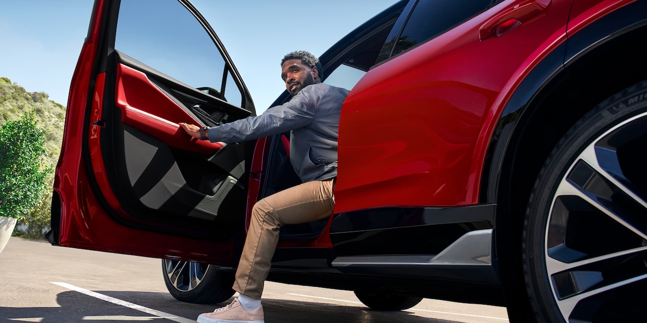 A Man Opening the Driver's Side Door on the 2026 Chevy Blazer EV