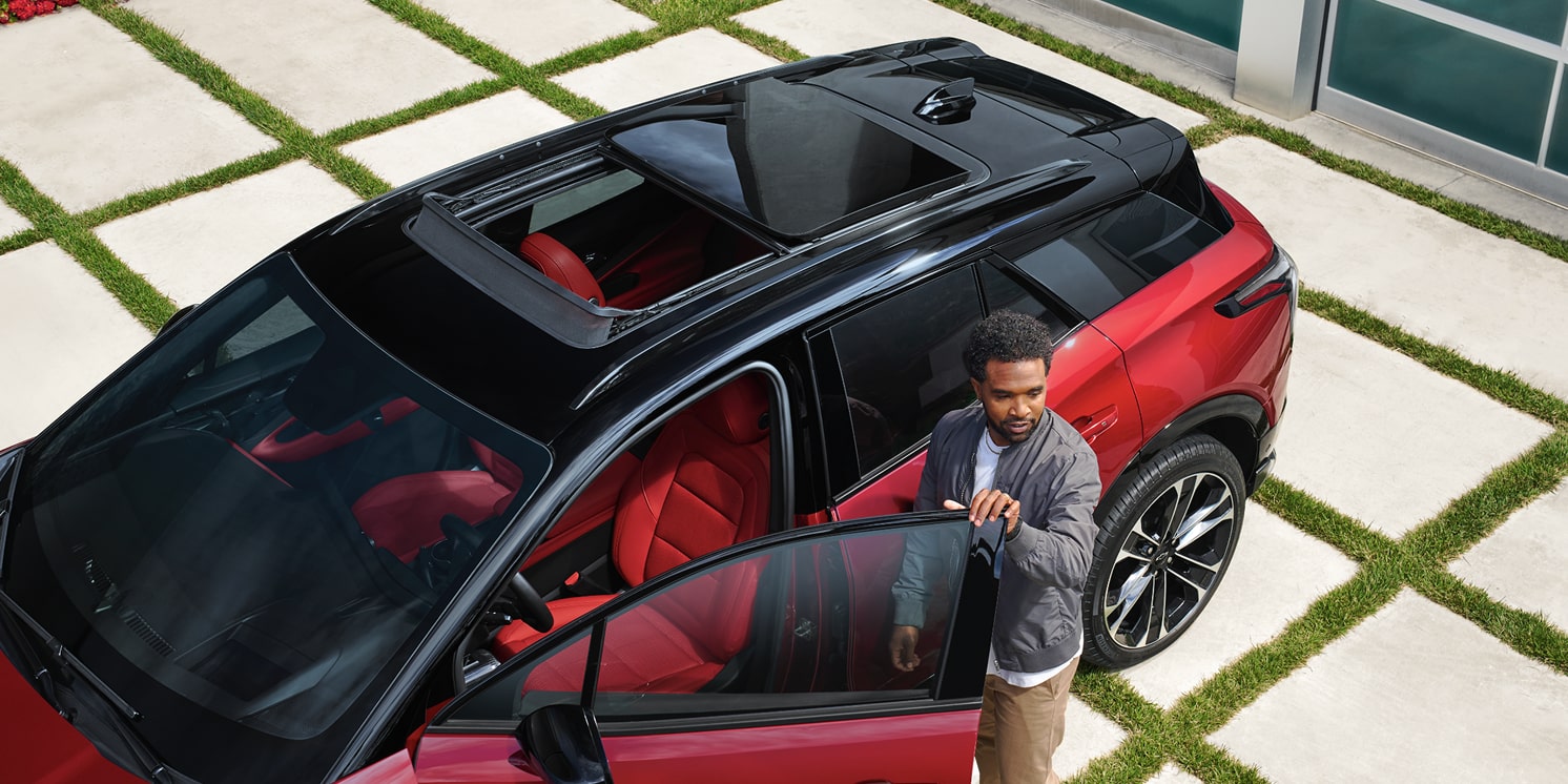 A Man Entering His 2026 Chevy Blazer EV While Parked in the Driveway