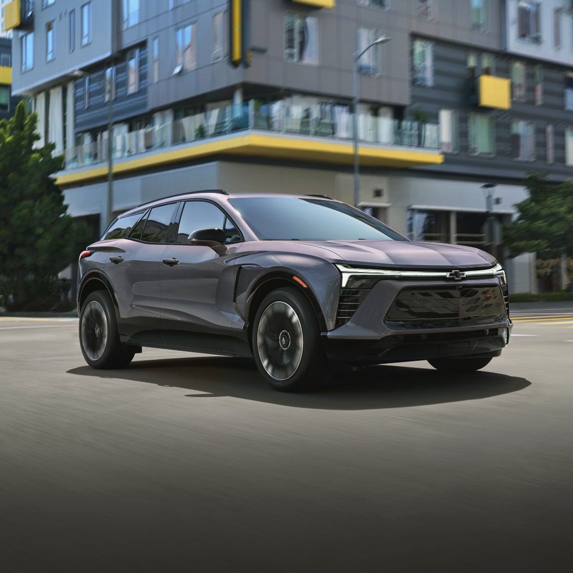 2026 Chevy Blazer EV Driving Through an Intersection in a City
