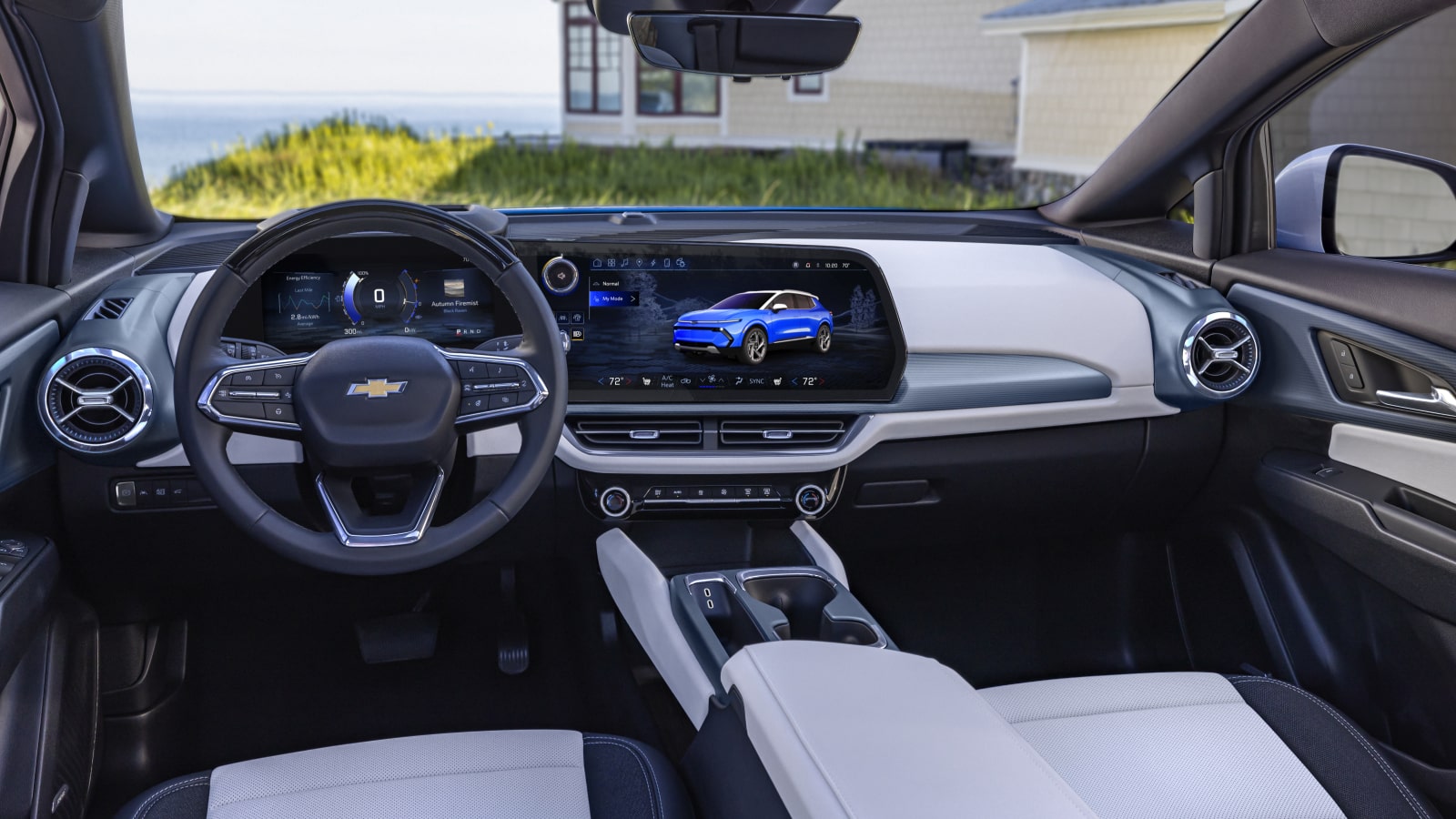 The Interior of a Chevrolet Equinox EV Featuring a Wide Dashboard With Digital Screens and Two-Tone Seats.