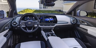 The Detailed Interior Cockpit of a Chevrolet Equinox EV, Showing the Steering Wheel and Dual Digital Displays.