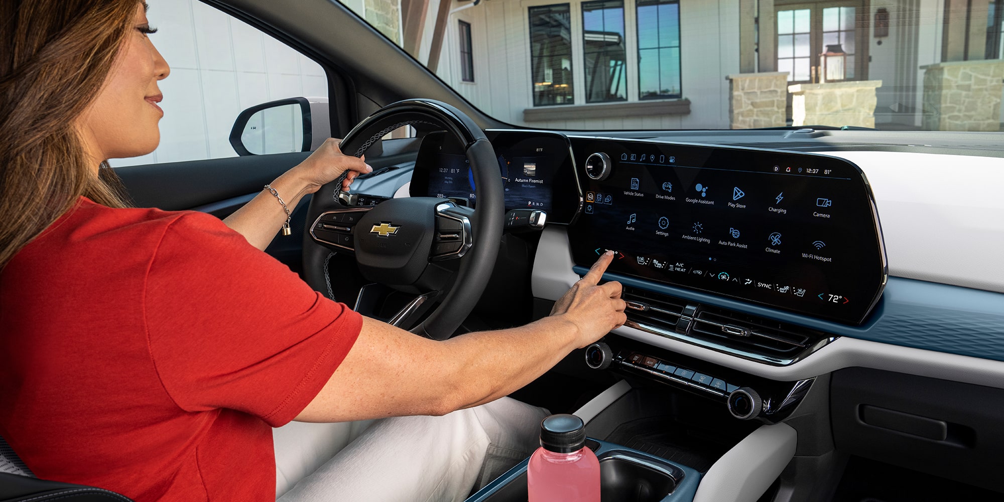 A Woman in a Red Shirt Touching the Center Console with a Digital Screen