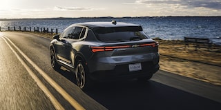 2026 Chevy Equinox EV Driving Next to a Lake at Sunset