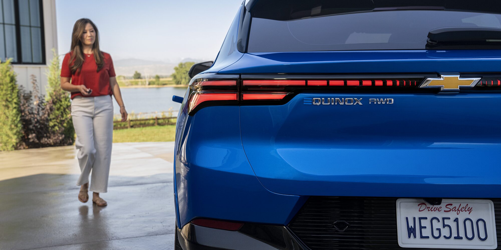 A Woman Walking Toward her Parked 2026 Chevy Equinox EV
