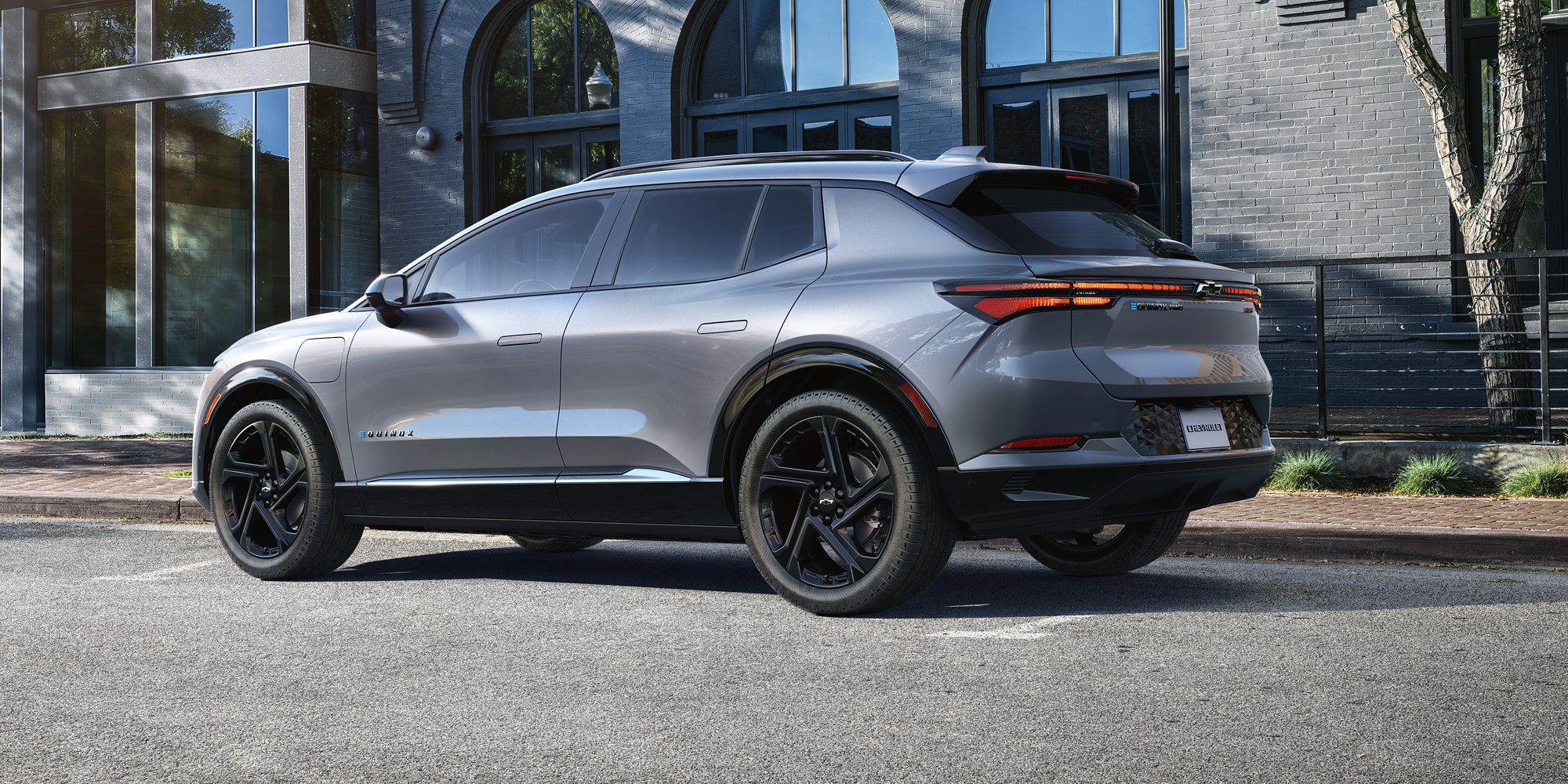 2026 Chevy Equinox EV Driving Past a Storefront