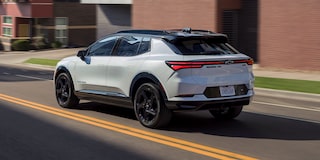 2026 Chevy Equinox EV Driving Past Apartment Buildings in a City