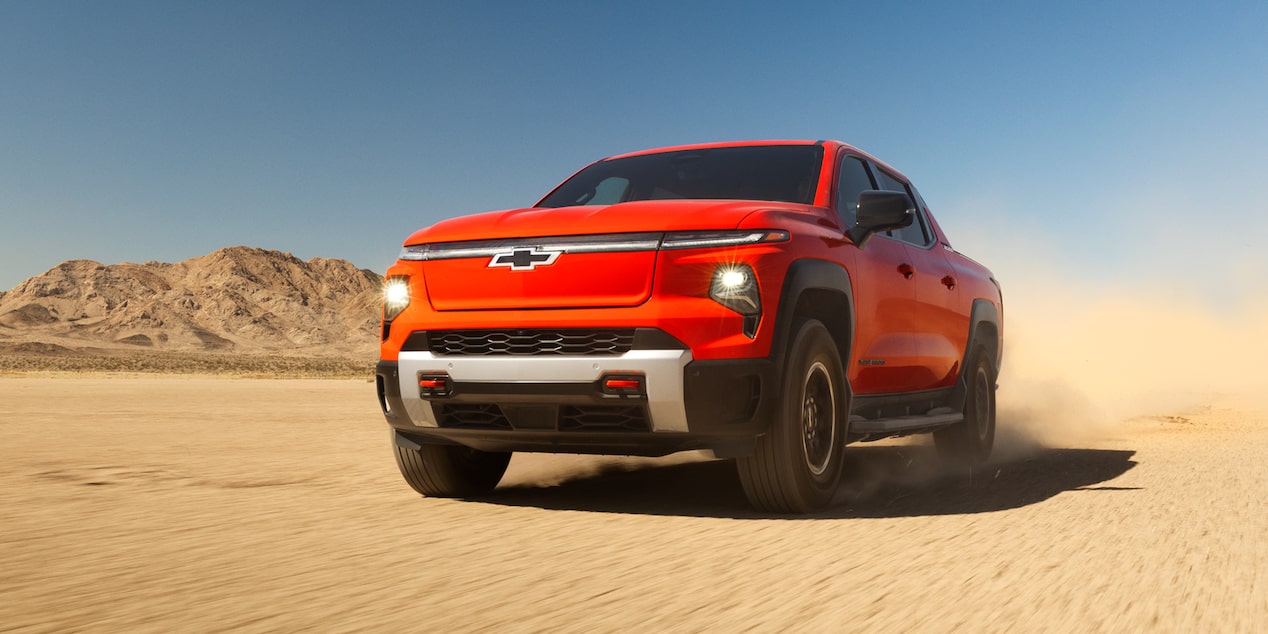 Three Quarters View of an Orange 2026 Chevy Silverado EV in the Middle of a Desert