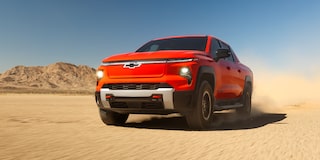 Three Quarters View of an Orange 2026 Chevy Silverado EV in the Middle of a Desert
