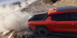 Overhead View of an Orange 2026 Silverado EV Drifting through the Desert with Dust Flying Everywhere