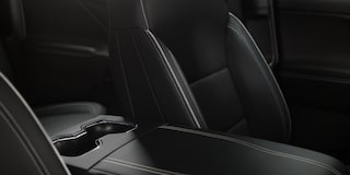 Three Quarters View of the Full Interior of a 2026 Chevy Silverado EV Next to a Body of Water under a Cloudy Sky