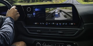 A Man Is Seen Driving a 2026 Chevy Silverado EV with the Display Dashboard Showing Footage of the Cargo in the Back