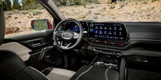 Three Quarters View of the Full Interior of a 2026 Chevy Silverado EV Next to a Body of Water under a Cloudy Sky